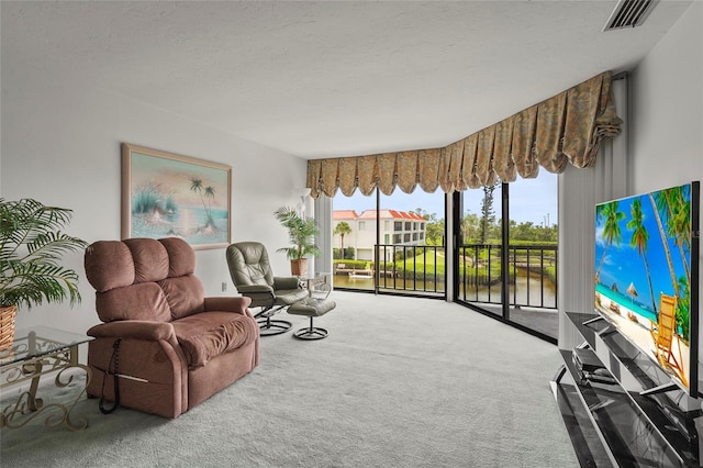 3705 E Bay Dr Unit 205, Holmes Beach, FL 34217 - living area with carpet flooring and a textured ceiling