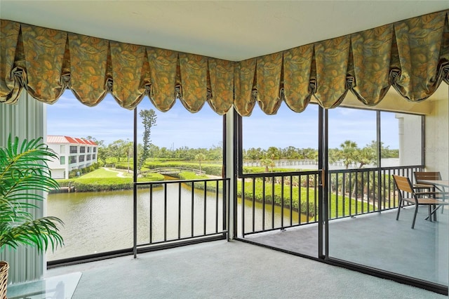 3705 E Bay Dr Unit 205, Holmes Beach, FL 34217 - unfurnished sunroom with a water view