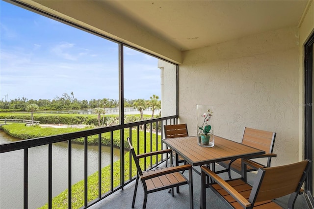 3705 E Bay Dr Unit 205, Holmes Beach, FL 34217 - balcony with a water view and outdoor dining space