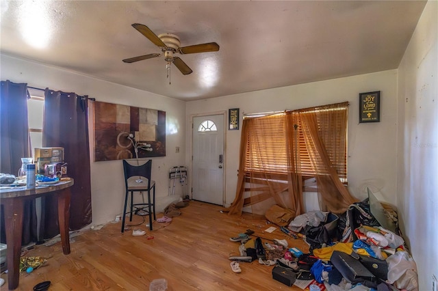 foyer entrance featuring wood finished floors and a ceiling fan