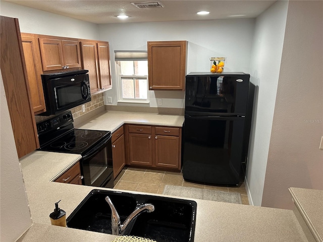 8809 White Sage Loop, Lakewood Ranch, FL 34202 - kitchen featuring black appliances, light countertops, brown cabinets, decorative backsplash, and recessed lighting