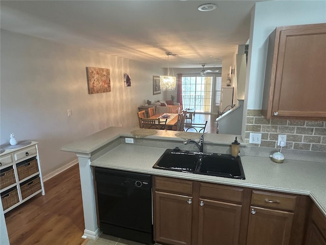 8809 White Sage Loop, Lakewood Ranch, FL 34202 - kitchen with dishwasher, light countertops, decorative backsplash, wood finished floors, and a peninsula