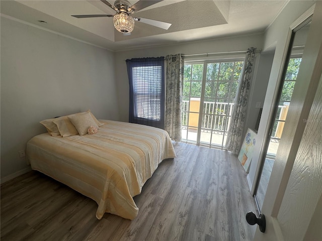 8809 White Sage Loop, Lakewood Ranch, FL 34202 - bedroom featuring access to outside, wood finished floors, multiple windows, and ornamental molding