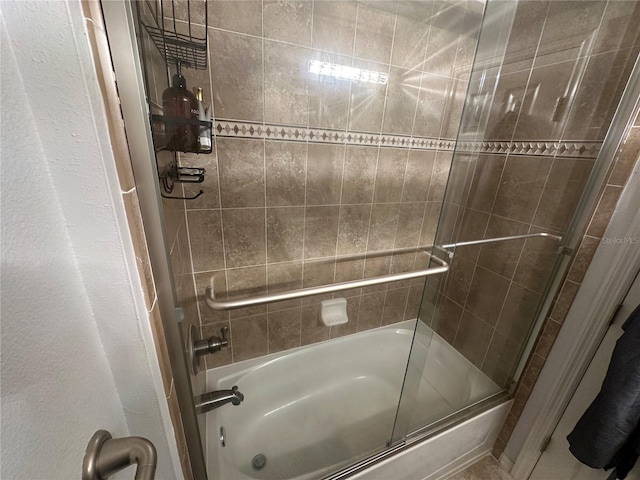 8809 White Sage Loop, Lakewood Ranch, FL 34202 - full bath featuring combined bath / shower with glass door and a textured wall