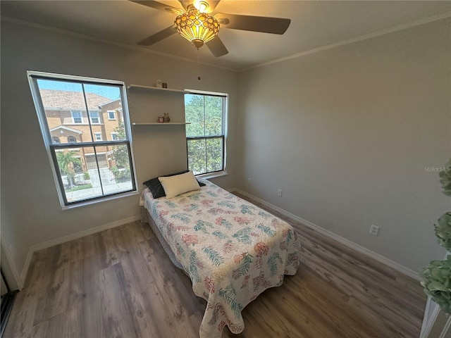 8809 White Sage Loop, Lakewood Ranch, FL 34202 - bedroom with wood finished floors, crown molding, and a ceiling fan