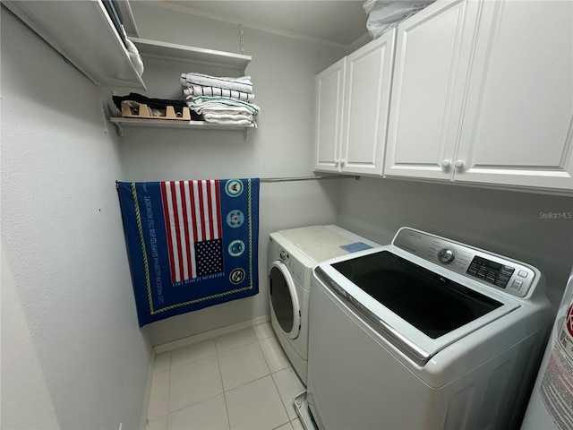 8809 White Sage Loop, Lakewood Ranch, FL 34202 - laundry area featuring washer and dryer, cabinet space, and light tile patterned flooring