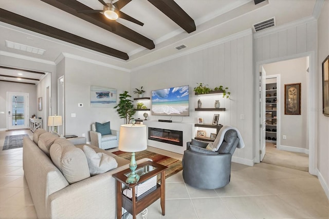 10347 Coastal Shores Dr, Parrish, FL 34219 - living room featuring light tile patterned flooring, beamed ceiling, a ceiling fan, a glass covered fireplace, and crown molding