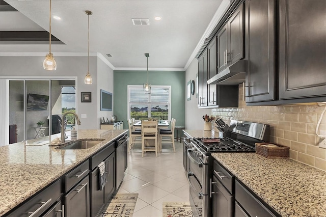 10347 Coastal Shores Dr, Parrish, FL 34219 - kitchen with stainless steel appliances, under cabinet range hood, tasteful backsplash, light tile patterned floors, and ornamental molding