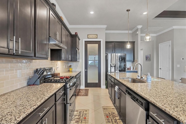 10347 Coastal Shores Dr, Parrish, FL 34219 - kitchen featuring appliances with stainless steel finishes, under cabinet range hood, dark brown cabinets, decorative backsplash, and light stone counters