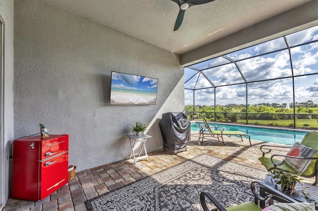 10347 Coastal Shores Dr, Parrish, FL 34219 - view of patio with an outdoor pool, a ceiling fan, glass enclosure, and area for grilling