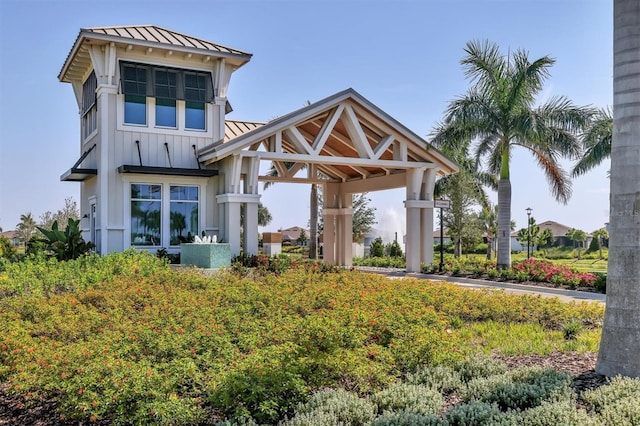10347 Coastal Shores Dr, Parrish, FL 34219 - rear view of house featuring a standing seam roof, a metal roof, board and batten siding, and a gazebo