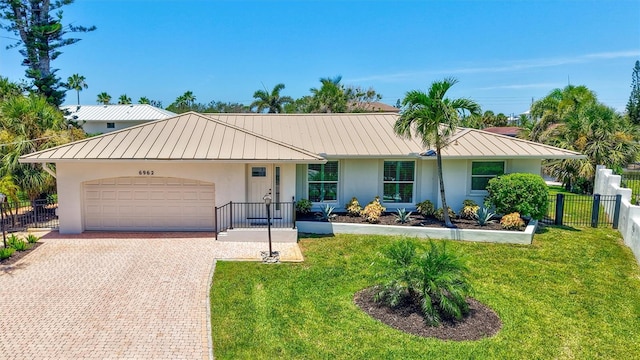 6962 Belgrave Dr, Sarasota, FL 34242 - single story home with a standing seam roof, stucco siding, and a metal roof