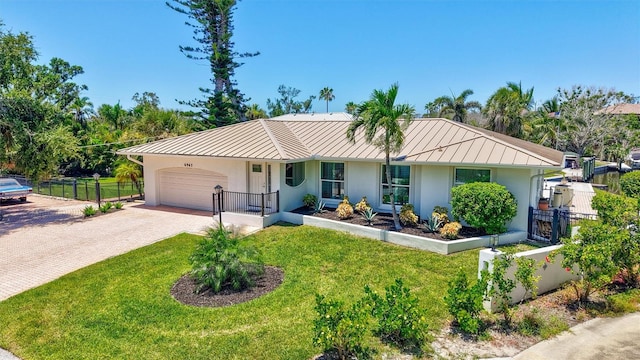 6962 Belgrave Dr, Sarasota, FL 34242 - single story home with a standing seam roof, stucco siding, an attached garage, a metal roof, and decorative driveway