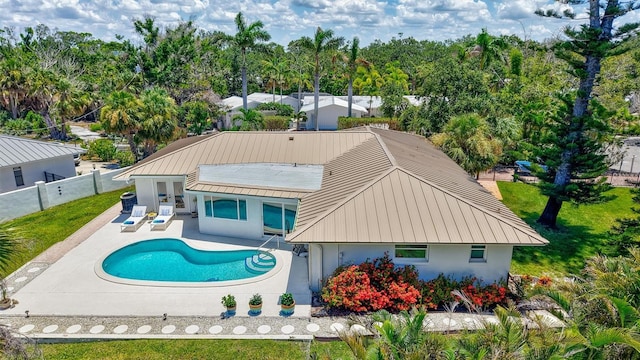 6962 Belgrave Dr, Sarasota, FL 34242 - back of house with a fenced backyard, a patio, stucco siding, and a metal roof
