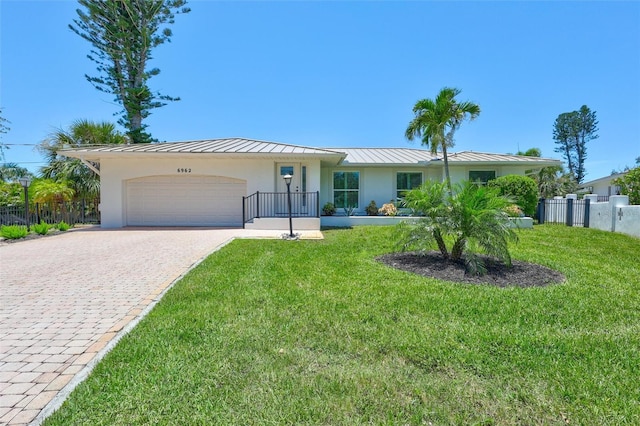 6962 Belgrave Dr, Sarasota, FL 34242 - ranch-style house featuring a standing seam roof, stucco siding, an attached garage, decorative driveway, and a metal roof