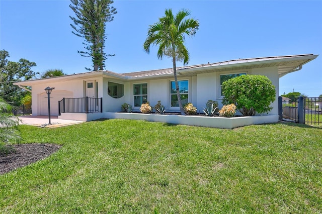 6962 Belgrave Dr, Sarasota, FL 34242 - back of property featuring stucco siding, a metal roof, a standing seam roof, and an attached garage