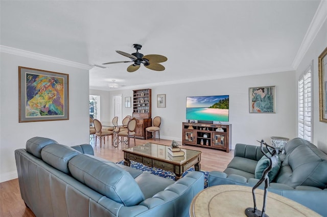 6962 Belgrave Dr, Sarasota, FL 34242 - living area featuring plenty of natural light, crown molding, ceiling fan, and wood finished floors