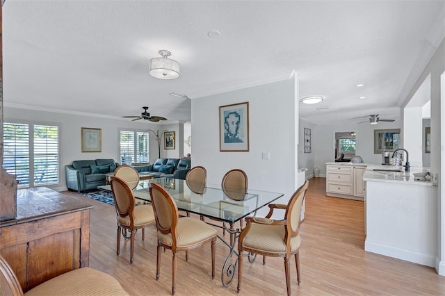 6962 Belgrave Dr, Sarasota, FL 34242 - dining space with a ceiling fan, healthy amount of natural light, ornamental molding, and light wood-type flooring