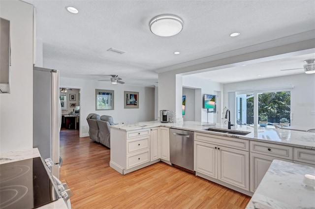 6962 Belgrave Dr, Sarasota, FL 34242 - kitchen with appliances with stainless steel finishes, a ceiling fan, open floor plan, light wood finished floors, and light stone counters