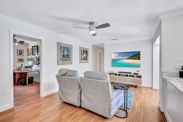 6962 Belgrave Dr, Sarasota, FL 34242 - living room featuring ceiling fan, light wood-style floors, a textured ceiling, crown molding, and an office area