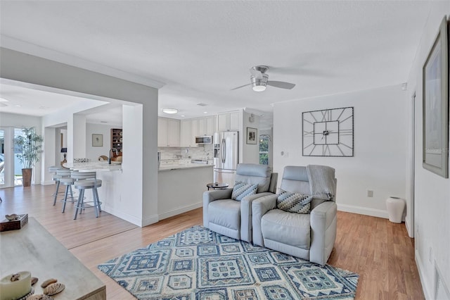 6962 Belgrave Dr, Sarasota, FL 34242 - living room featuring ceiling fan and light wood finished floors