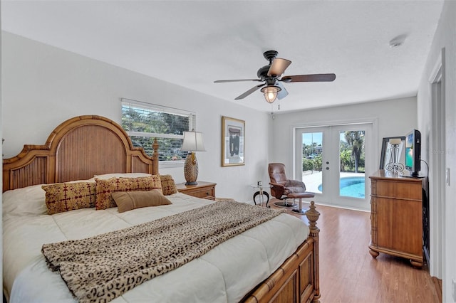 6962 Belgrave Dr, Sarasota, FL 34242 - bedroom featuring access to outside, french doors, wood finished floors, and a ceiling fan