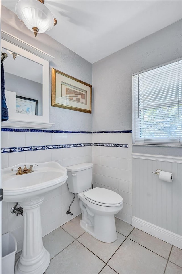6962 Belgrave Dr, Sarasota, FL 34242 - bathroom with a wainscoted wall and tile patterned flooring