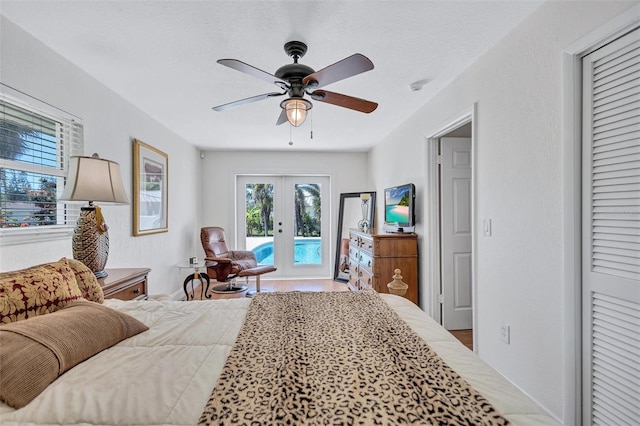 6962 Belgrave Dr, Sarasota, FL 34242 - bedroom with access to exterior, french doors, a ceiling fan, and wood finished floors