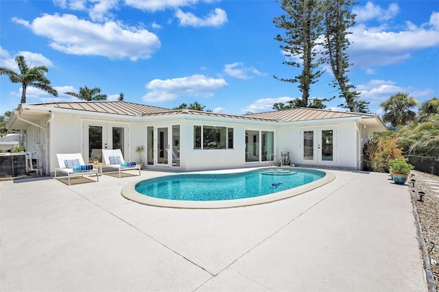 6962 Belgrave Dr, Sarasota, FL 34242 - rear view of property with french doors, a standing seam roof, a patio area, and stucco siding