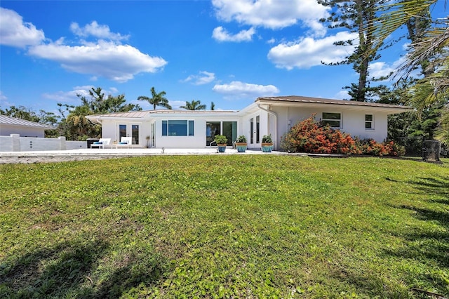 6962 Belgrave Dr, Sarasota, FL 34242 - view of front of home with french doors, stucco siding, and a patio area