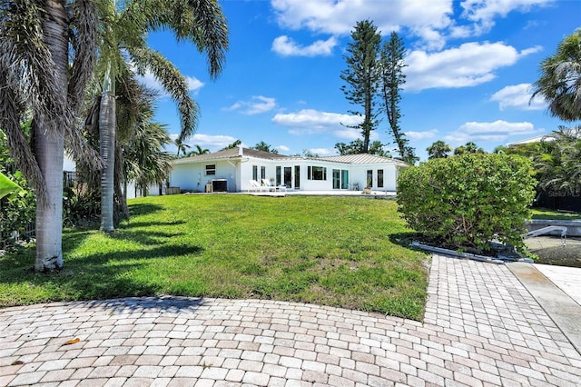 6962 Belgrave Dr, Sarasota, FL 34242 - view of front of house with a front yard and a patio
