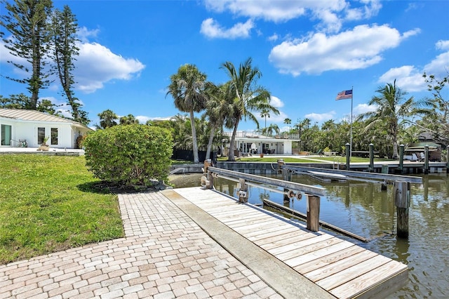 6962 Belgrave Dr, Sarasota, FL 34242 - dock area with a water view, boat lift, and a lawn