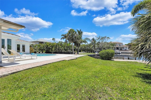 6962 Belgrave Dr, Sarasota, FL 34242 - view of grassy yard with french doors, an outdoor pool, and a patio