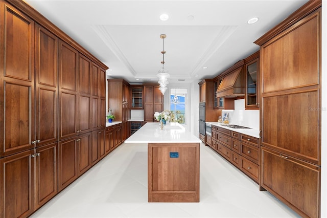 2251 Gulf Of Mexico Dr Unit 301, Longboat Key, FL 34228 - kitchen featuring premium range hood, a tray ceiling, glass insert cabinets, cooktop, and recessed lighting