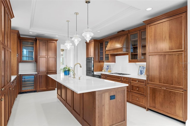 2251 Gulf Of Mexico Dr Unit 301, Longboat Key, FL 34228 - kitchen featuring beverage cooler, custom range hood, a tray ceiling, recessed lighting, and brown cabinets