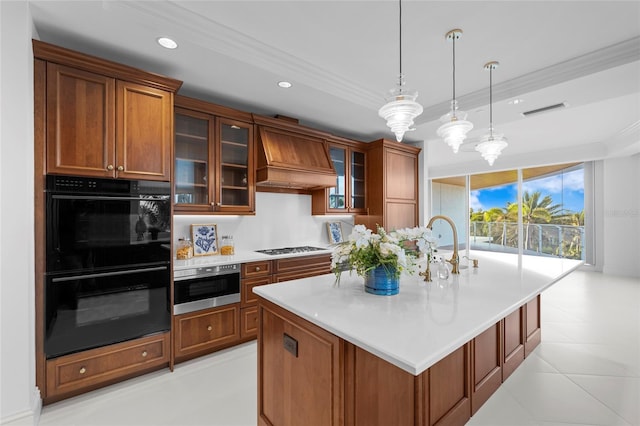 2251 Gulf Of Mexico Dr Unit 301, Longboat Key, FL 34228 - kitchen with decorative light fixtures, light countertops, brown cabinets, custom exhaust hood, and a kitchen island with sink