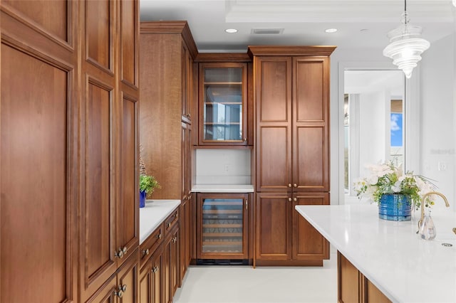 2251 Gulf Of Mexico Dr Unit 301, Longboat Key, FL 34228 - kitchen with wine cooler, light countertops, recessed lighting, glass insert cabinets, and pendant lighting