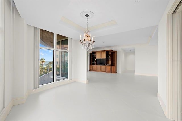 2251 Gulf Of Mexico Dr Unit 301, Longboat Key, FL 34228 - unfurnished living room featuring a chandelier and baseboards
