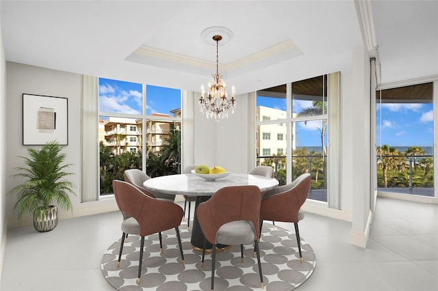 2251 Gulf Of Mexico Dr Unit 301, Longboat Key, FL 34228 - dining space featuring a chandelier, light tile patterned flooring, and a raised ceiling
