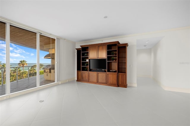 2251 Gulf Of Mexico Dr Unit 301, Longboat Key, FL 34228 - unfurnished living room featuring a wall of windows, a water view, and ornamental molding