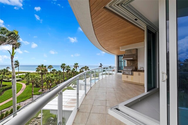 2251 Gulf Of Mexico Dr Unit 301, Longboat Key, FL 34228 - balcony with a water view and exterior kitchen