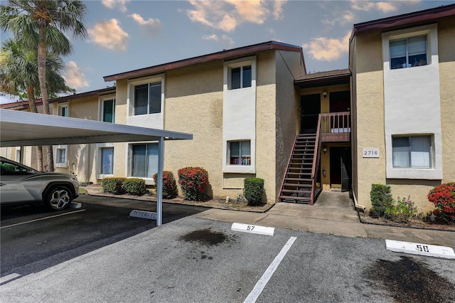 2716 Hidden Lake Blvd Unit C, Sarasota, FL 34237 - view of property featuring covered and uncovered parking and stairs
