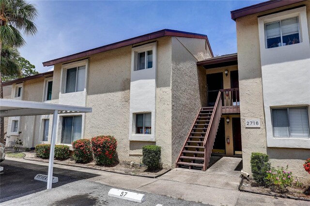 2716 Hidden Lake Blvd Unit C, Sarasota, FL 34237 - view of building exterior featuring a parking lot and stairs