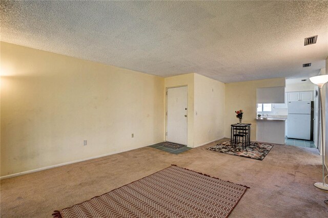 2716 Hidden Lake Blvd Unit C, Sarasota, FL 34237 - unfurnished living room with carpet floors and a textured ceiling