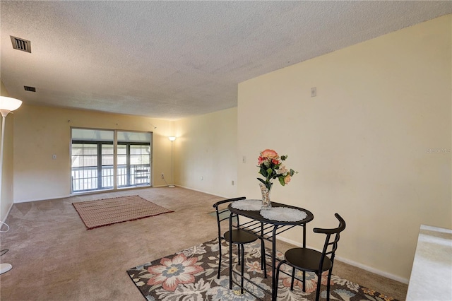2716 Hidden Lake Blvd Unit C, Sarasota, FL 34237 - dining room with a textured ceiling and carpet floors