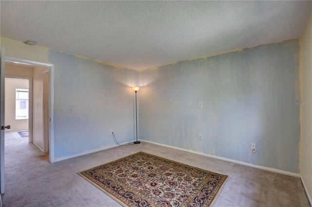 2716 Hidden Lake Blvd Unit C, Sarasota, FL 34237 - spare room featuring carpet, a textured ceiling, and a smoke detector