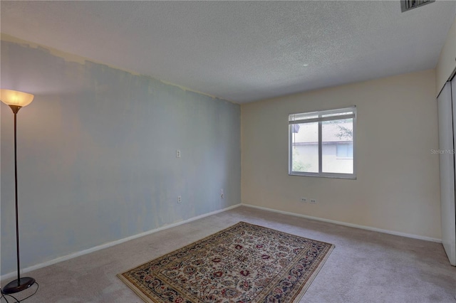 2716 Hidden Lake Blvd Unit C, Sarasota, FL 34237 - carpeted spare room featuring a textured ceiling and baseboards