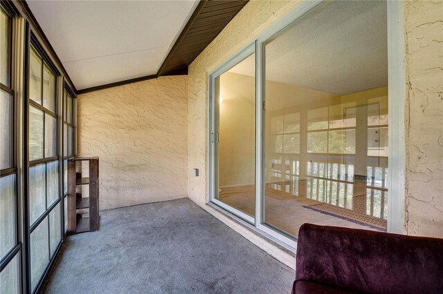 2716 Hidden Lake Blvd Unit C, Sarasota, FL 34237 - unfurnished sunroom featuring a textured wall and carpet