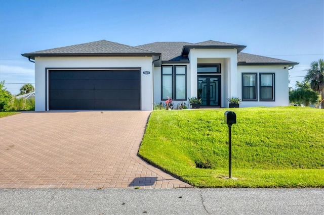 10270 Castanet Ave, Englewood, FL 34224 - prairie-style house with decorative driveway, stucco siding, a front yard, and an attached garage