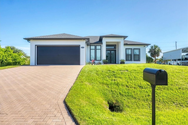 10270 Castanet Ave, Englewood, FL 34224 - prairie-style house featuring stucco siding, an attached garage, french doors, and a front lawn